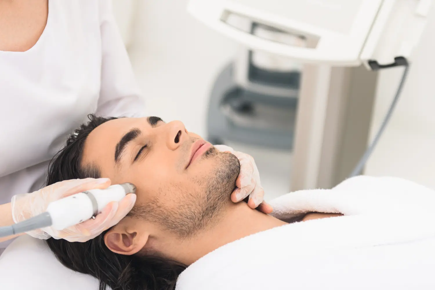 Mann mit Kavitationspeeling im Schönheitssalon